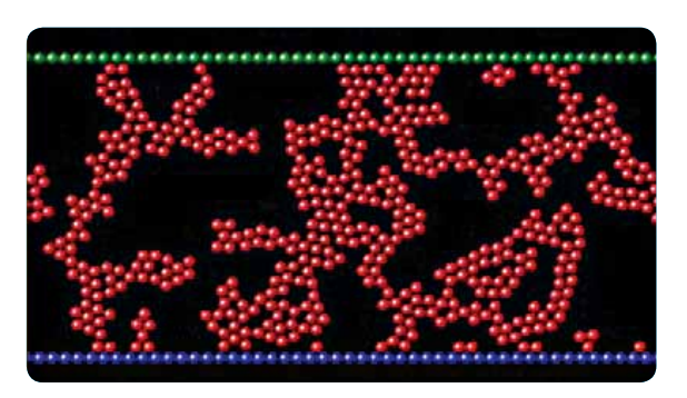 The image shows a snapshot of a particle packing of colloidal particles undergoing compression. The simulations are performed using the molecular dynamics simulation code, LAMMPS.